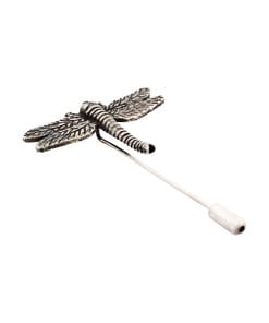 Close-up of a textured metal dragonfly figure attached to a thin white stem on a white background.